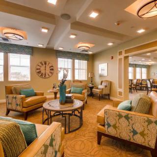 A modern, cozy living room with comfortable seating and elegant lighting fixtures.