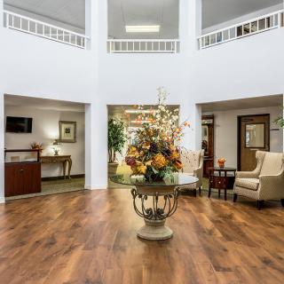 A beautifully decorated lobby with floral arrangements and comfortable seating.
