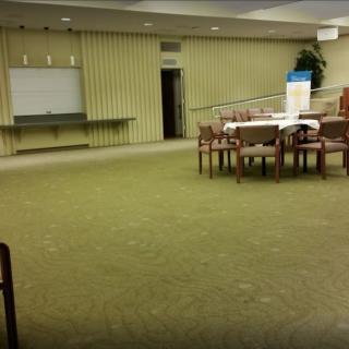 An empty conference room with a table and chairs arranged for a meeting.