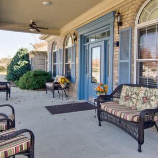 A welcoming porch with comfortable seating and vibrant plants.
