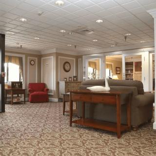 A cozy lobby area featuring comfortable seating with sofas and armchairs, decorated in a classic style.