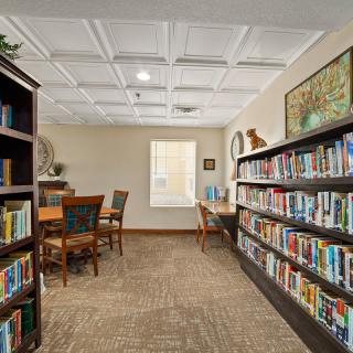 A cozy library space with bookshelves and a seating area for reading.