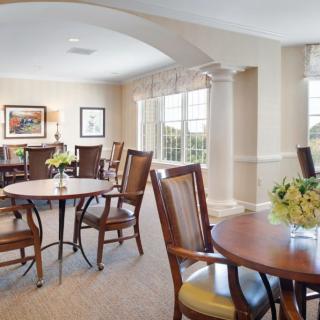 A bright and spacious dining area with elegant furniture and large windows.