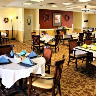 An empty restaurant dining area with neatly arranged tables and chairs.