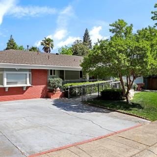 A suburban house with a driveway and landscaped front yard.