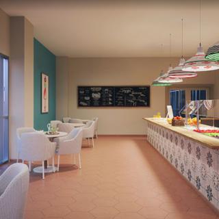 A cozy cafe interior featuring a seating area and a stylish counter with decorative lighting.