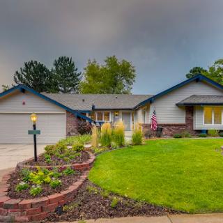 A charming single-story home with a well-maintained front yard and garden.