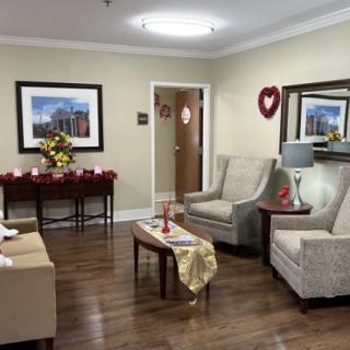 A cozy living room with comfortable seating, wall art, and decorative elements.