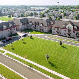Aerial view of a residential complex featuring manicured lawns and well-maintained buildings.