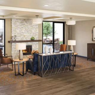 A cozy, modern living room with a fireplace and stylish furnishings.