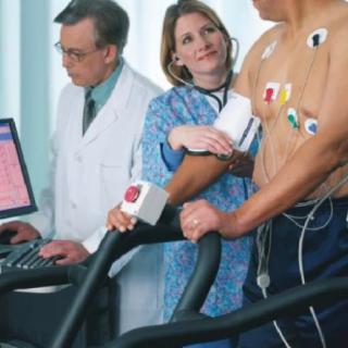 A patient undergoing a cardiac stress test with medical professionals monitoring the procedure.
