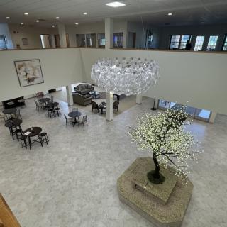 Spacious and modern lobby area featuring elegant furniture and decorative lighting.