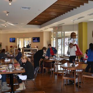 People dining inside a restaurant with modern interior design.