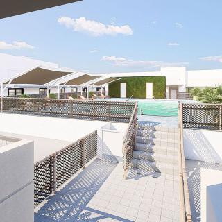 A modern rooftop area featuring a swimming pool and sleek architectural elements under a clear blue sky.