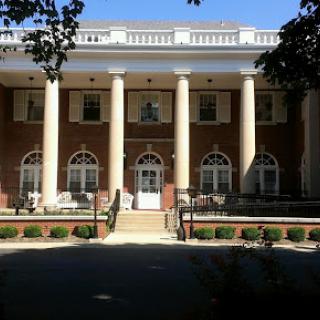 A grand building featuring classic architecture with prominent columns and detailed windows.