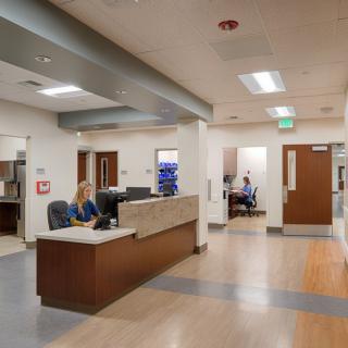 A clean and modern hospital reception area with desks and hallways.