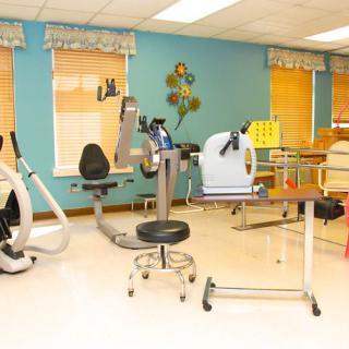 A well-equipped rehabilitation and exercise room with various fitness machines.