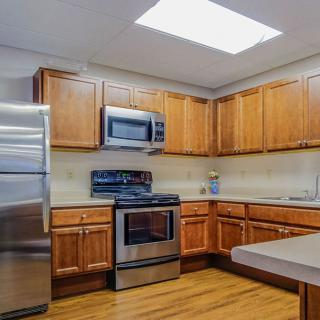 A modern kitchen featuring wooden cabinets and stainless steel appliances.