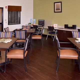 A spacious dining area featuring modern furnishings and a welcoming atmosphere.