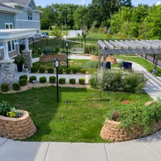 Beautifully landscaped garden with a lush lawn, pathways, and various plants.