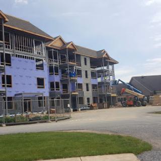 A construction site featuring a multi-story building under development.