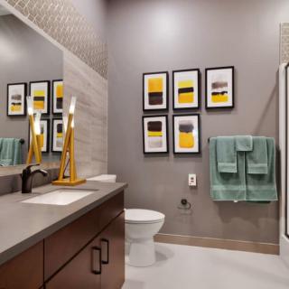 Modern bathroom with contemporary decor and framed artwork.