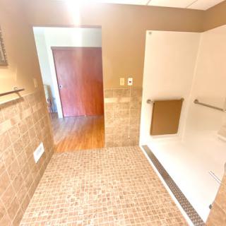 A well-designed bathroom featuring a spacious shower area and elegant tile work.