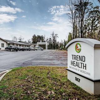 Trend Health clinic with parking area and signage.