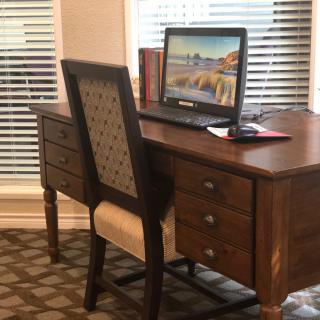 A home office setup with a wooden desk and computer.