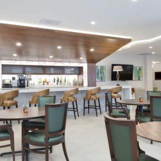 A modern cafe interior with a bar area and seating arrangement.