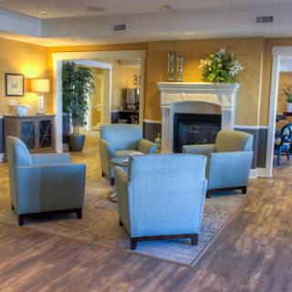 A cozy living room setup featuring comfortable chairs and a welcoming fireplace.