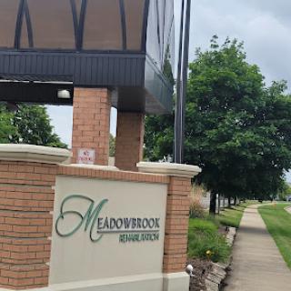 Entrance sign for Meadowbrook Manors, showcasing the community's welcoming atmosphere.