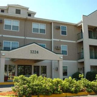 A modern apartment building with a welcoming front entrance and well-maintained landscaping.