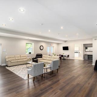 A modern and spacious living room with neutral tones and an open layout.
