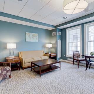 A cozy living room with comfortable seating, elegant lighting, and modern decor.