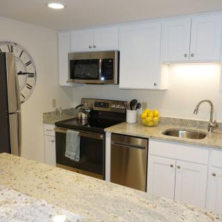 A modern kitchen with stainless steel appliances and granite countertops.