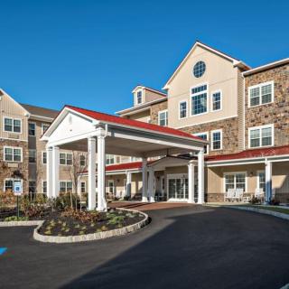 A large residential building with a welcoming entrance and landscaped surroundings.