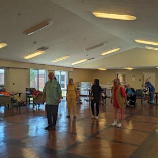Seniors participating in a dance class at a community center.