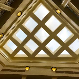 A beautifully designed ceiling featuring a geometric skylight with a grid pattern.