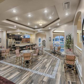 A spacious and modern lounge area with elegant lighting and comfortable seating.