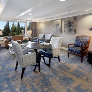 A cozy living room with comfortable seating and large windows.