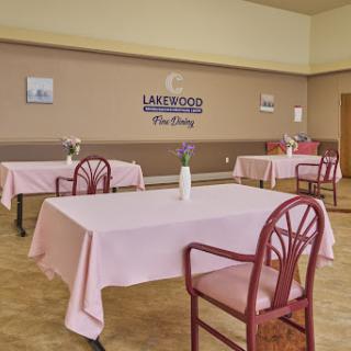 A cozy dining area featuring neatly arranged tables with pink tablecloths, ready for guests.