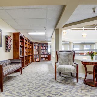 A cozy library corner with bookshelves and comfortable seating.