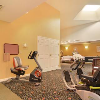 A well-equipped indoor gym featuring exercise bicycles and fitness facilities.