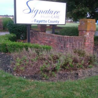 Entrance sign for Signature Care in Fayette County, featuring landscaped surroundings.