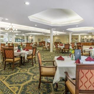 An elegant restaurant interior with neatly arranged dining tables and chairs.