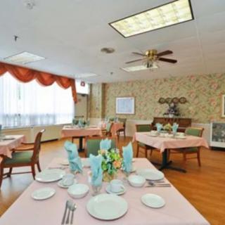 A well-decorated dining room with neatly set tables and chairs.