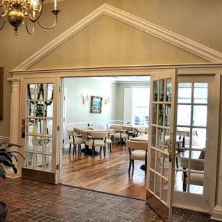 A stylish dining room with French doors and elegant decor.