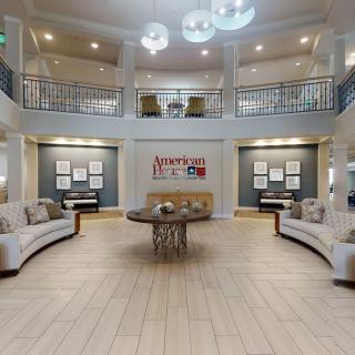 A spacious and elegantly designed lobby with modern furniture and lighting.