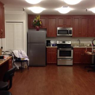 A modern kitchen with wooden cabinets and stainless steel appliances.